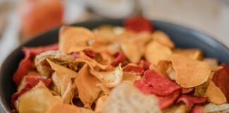 Zdrowe chipsy warzywne – łatwe przepisy na zdrową przekąskę Atrakcyjna miska zdrowych chipsów warzywnych, skomponowanych z różnorodnych warzyw, obok przepisów na zdrowe chipsy warzywne